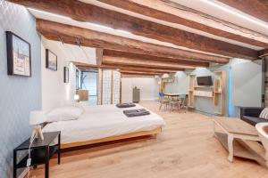 a bedroom with a large bed in a room with wooden ceilings at La Cabane Bellecour in Lyon