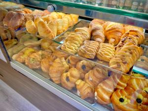 a display case in a bakery filled with lots of pastries at Deluxe Spaccanapoli in Naples