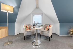 a dining room with a table and two chairs at Ferienwohnung Bude 14 Dagebüll in Dagebüll