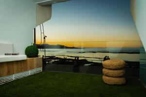 a room with a view of the ocean and a building at OceanSound White in Las Palmas de Gran Canaria