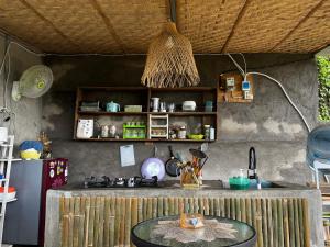 a kitchen with a counter and a table in a room at Laa Cabana Lombok Glamping in Sapit