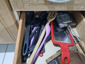 a drawer filled with utensils in a drawerlictsangering at Oca do Ric in Imbituba +12 photos