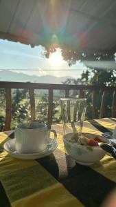 a table with a cup and a bowl of food at Ridge Boundary View in Dambulla