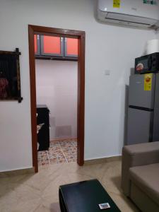 a living room with a door leading to a kitchen at Saceaas homes in Accra