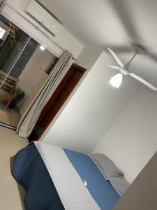 Cette chambre comprend un lit et une fenêtre avec un ventilateur. dans l'établissement RM hospedagem, à Cabo Frio 10 autres photos