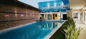 a house with a swimming pool next to a building at Hotel Casa Morales in Yopal