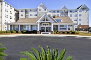 a large apartment building with a driveway in front of it at Residence Inn by Marriott Gulfport-Biloxi Airport in Gulfport
