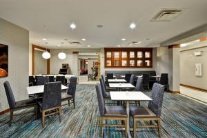 a dining room with tables and chairs and a cafeteria at Residence Inn by Marriott Gulfport-Biloxi Airport in Gulfport +25 photos