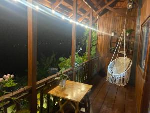 a porch with a hammock and a swing at Homestay Lưng Đồi in Buôn Dhă Prŏng +6 photos