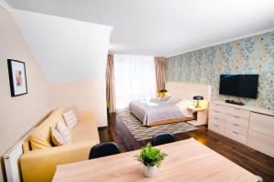 a hotel room with a bed and a television at Spirit Harrachov Superior Wellness Apartment - FREE Wellness, Wifi, Parking in Harrachov