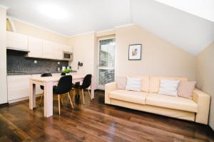 a living room with a couch and a table at Spirit Harrachov Superior Wellness Apartment - FREE Wellness, Wifi, Parking in Harrachov