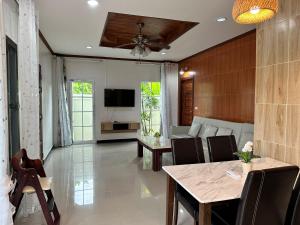 a living room with a table and a couch at 3BR Villa near Boat Avenue Laguna beach in Bang Tao Beach