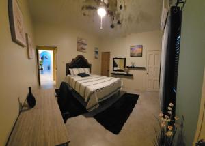 a bedroom with a bed and a table in a room at Addvantage Point Apartments in Montego Bay