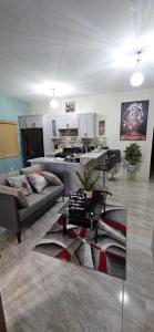a living room with a couch and a kitchen at Addvantage Point Apartments in Montego Bay