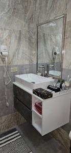 a bathroom with a sink and a mirror at Addvantage Point Apartments in Montego Bay +23 photos