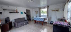 a living room with a couch and a chair at Yamini - Barra del Chuy in Barra del Chuy