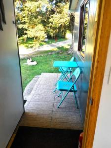 a blue picnic table on the porch of a house at Cabaña Familiar Puerto Varas in Puerto Varas