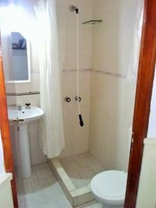 a bathroom with a shower and a toilet and a sink at Duplex a 500m de la playa in Villa Gesell