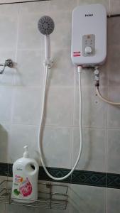 a shower in a bathroom with a soap dispenser at KaLong Bay Homestay Villa Seroja in Kampong Telok Kalong