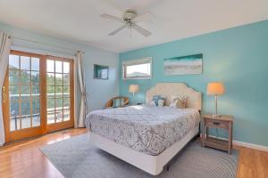 a bedroom with a bed and a ceiling fan at 1689 - Maison de la Mer in Poplar Branch