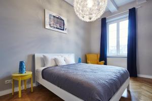 a bedroom with a bed and a chandelier at PlayRoom II Apartment in Krakow