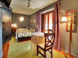 a bedroom with a bed and a table with a chair at Hostal Rural Txapi Txuri Logis Hotels in Murillo el Fruto