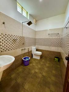 a bathroom with a toilet and a sink at Chilanka Lake View Resort in Alleppey +30 photos