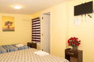 Voodi või voodid majutusasutuse Hostal Del Tuto toas