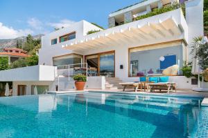 a villa with a swimming pool in front of a house at Hotel Villa Mahal in Kalkan