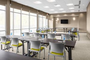 a conference room with tables and chairs and a tv at SpringHill Suites by Marriott Savannah Richmond Hill in Richmond Hill +15 photos