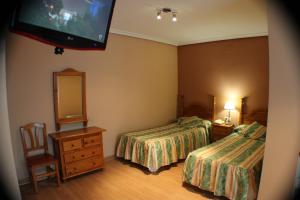 Postel nebo postele na pokoji v ubytování Hotel Las Nieves
