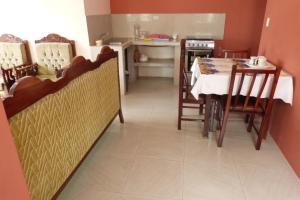 a kitchen and dining room with a table and chairs at Hostal Terito in Puerto Baquerizo Moreno