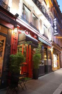 a store with plants in front of a building at Hotel Celtic in Paris