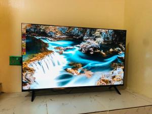 a large flat screen tv sitting on a wall at Capsule Queens Luxury Studio in Mombasa