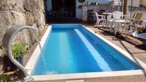 a swimming pool with a water fountain at Residencial Santa Teresa in Rio de Janeiro