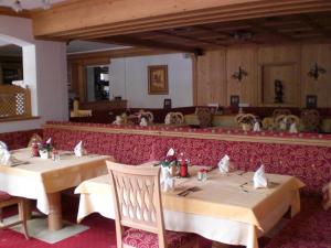 a dining room with two tables in a restaurant at Gampeler Hof in Galtür