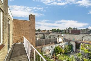 a balcony of a brick building with a staircase at Eindhoven City Center Apartment in Eindhoven