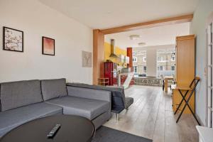 a living room with a couch and a table at Eindhoven City Center Apartment in Eindhoven