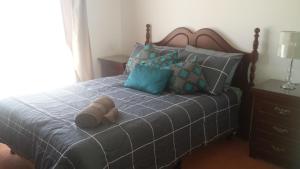 a bedroom with a bed with two towels on it at The Quorn-er House in Quorn