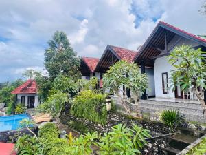 a villa with a swimming pool in a resort at Sela Cottages in Toyapakeh
