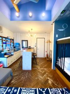 a room with blue ceilings and a kitchen with a table at Ohmachi Junxion in Kamakura