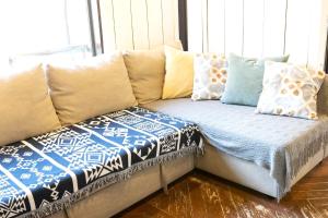 a couch with pillows on it in a room at Ohmachi Junxion in Kamakura