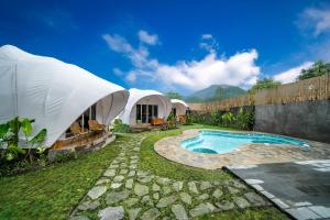 a luxury tent with a swimming pool in a yard at The Dewi Kintamani Luxury Glamping and Natural Hotspring in Kintamani