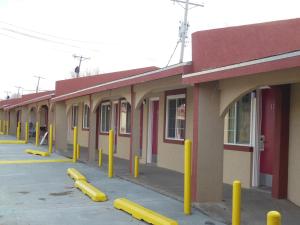 a row of yellow poles in front of a building at Route 66 Inn in Amarillo