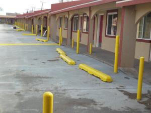 eine Reihe gelber Pole vor einem Gebäude in der Unterkunft Route 66 Inn in Amarillo