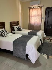 a room with three beds in a room at Acacia Villa Self Catering Guest House in Okahandja