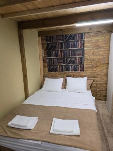 a bed in a room with two white pillows at Casa Acogedora in Hospitalet de Llobregat +14 photos