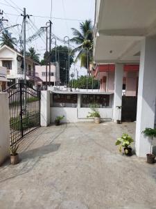 a white building with a gate in a courtyard at KINGS TOWN - Cyra Bliss County in Coimbatore