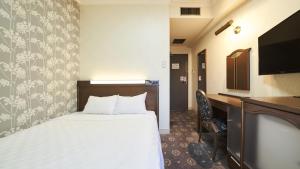 a hotel room with a bed and a desk at Hotel Paco Obihiro Ekimae in Obihiro +19 photos