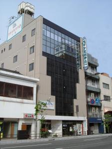 a large building on a city street with a street at Prince Hotel Shimonoseki in Shimonoseki